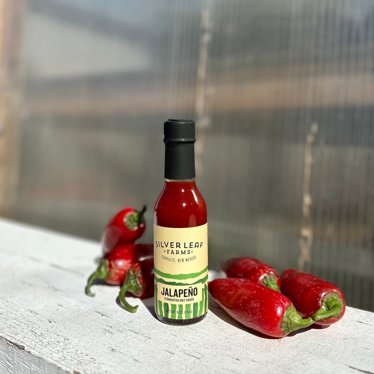 Silver Leaf Farms Red Jalapeño Fermented Hot Sauce bottle with red jalapeño peppers