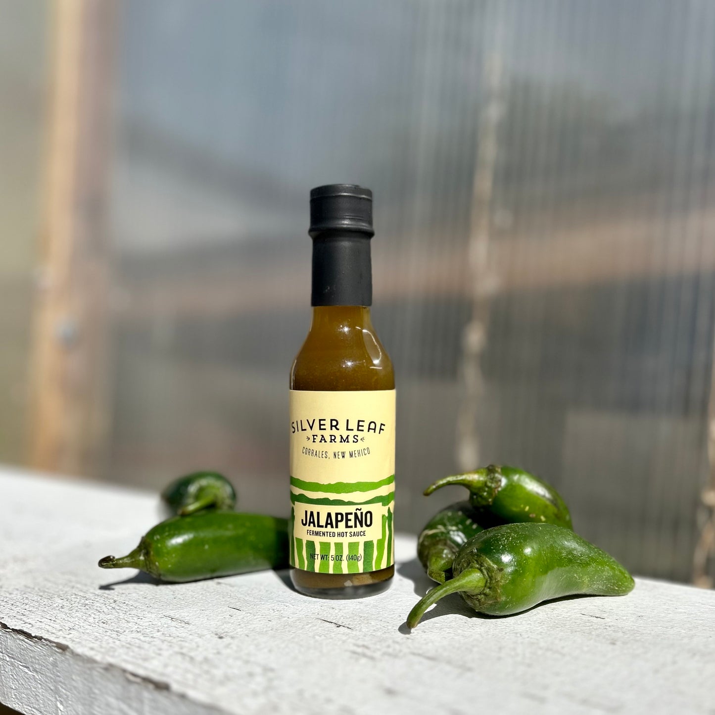 Silver Leaf Farms Jalapeño Fermented Hot Sauce bottle with jalapeño peppers