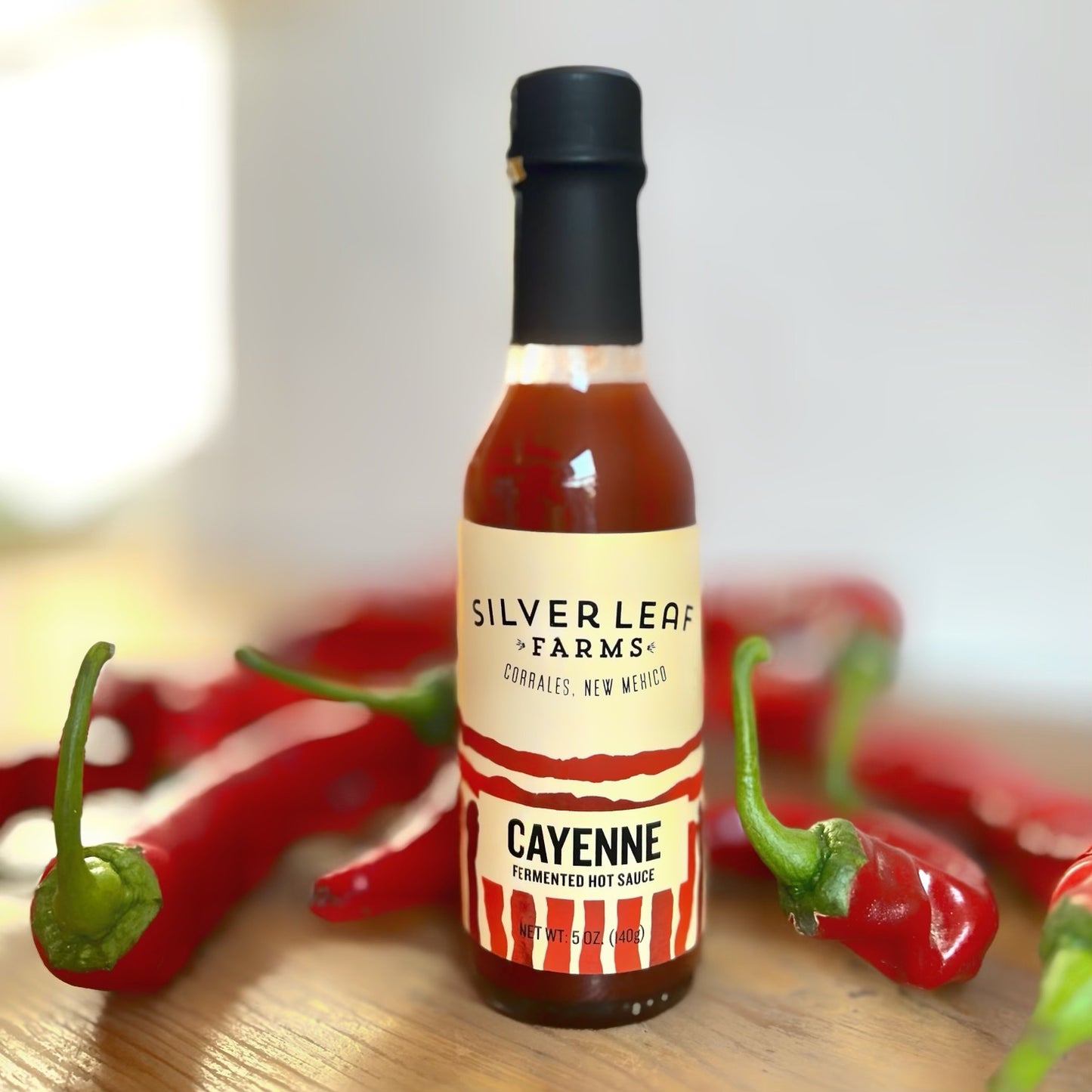 Silver Leaf Farms Cayenne Fermented Hot Sauce bottle with cayenne peppers