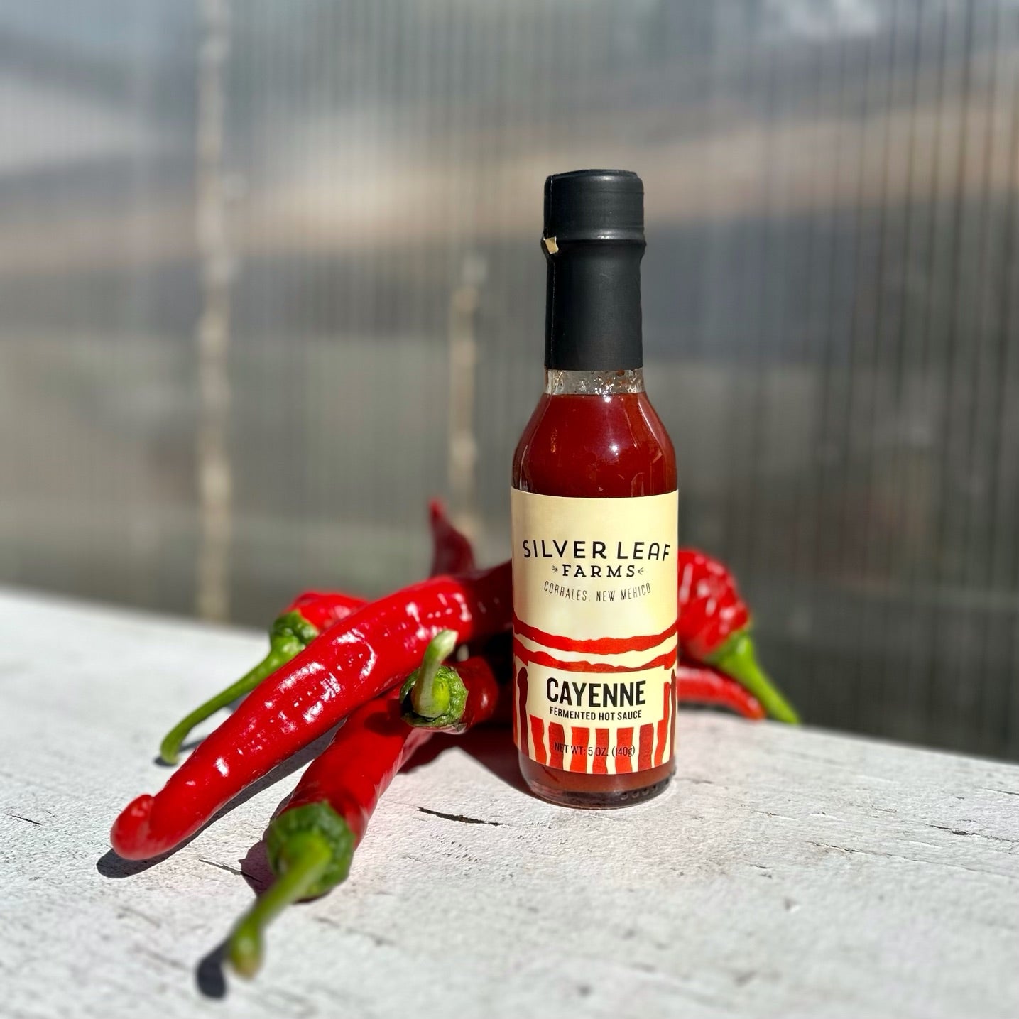 Silver Leaf Farms Cayenne Fermented Hot Sauce bottle with cayenne peppers