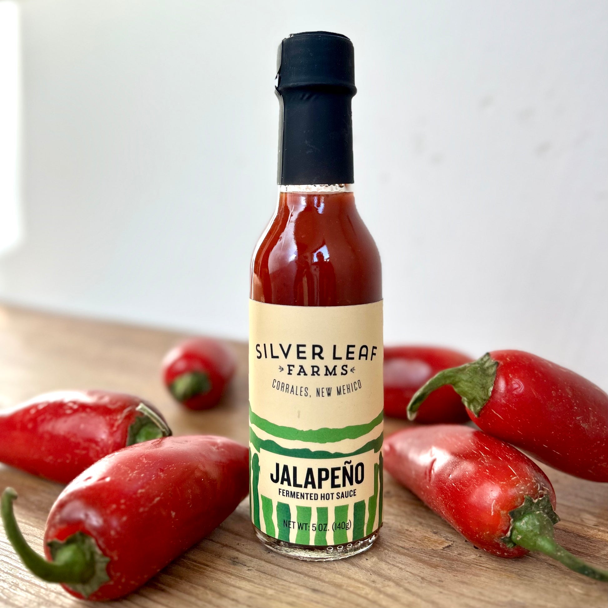 Silver Leaf Farms Red Jalapeño Fermented Hot Sauce bottle with red jalapeño peppers
